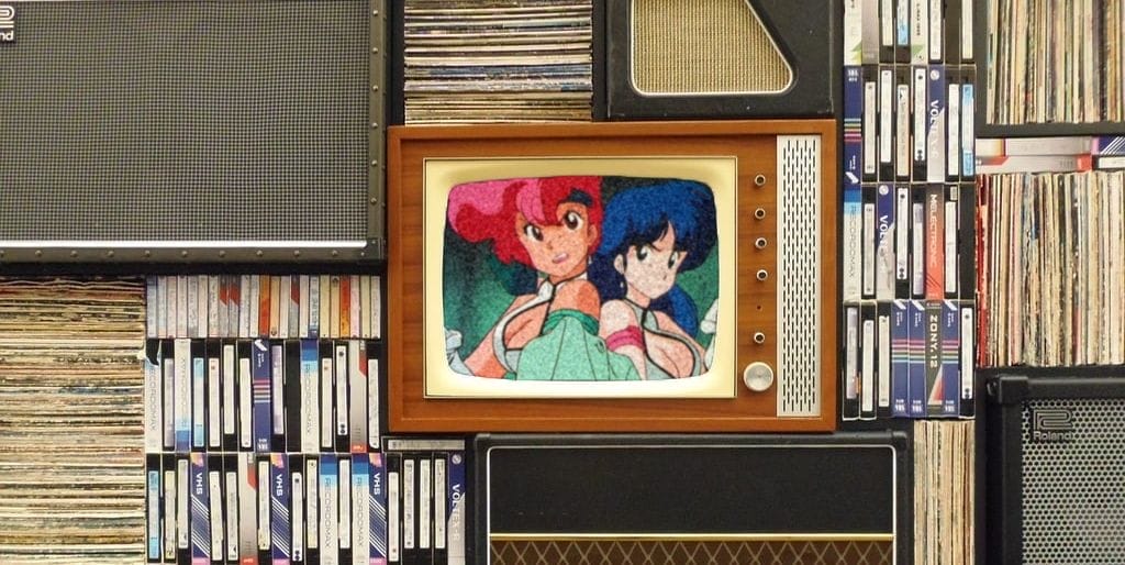 A CRT TV, sitting among books, LPs, and speakers, abandoned as Dirty Pair plays on it.