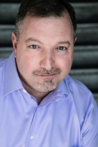 Headshot for voice actor and director John Swasey