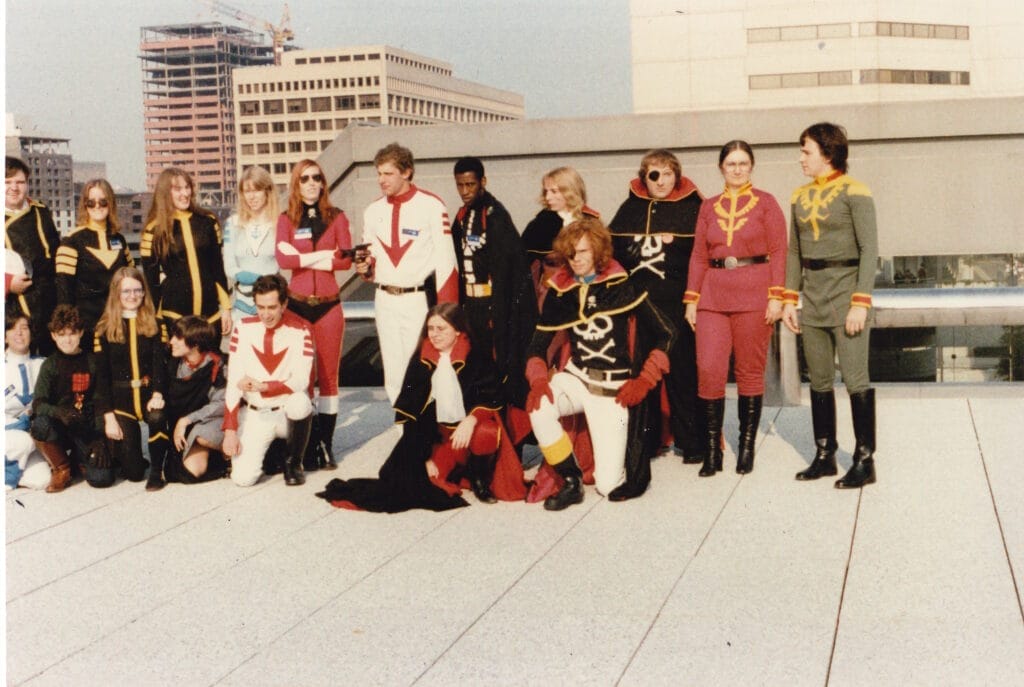 Photograph taken at Worldcon 1983, which depicts eighteen Star Blazers cosplayers on the roof of the Baltimore Convention Center.
