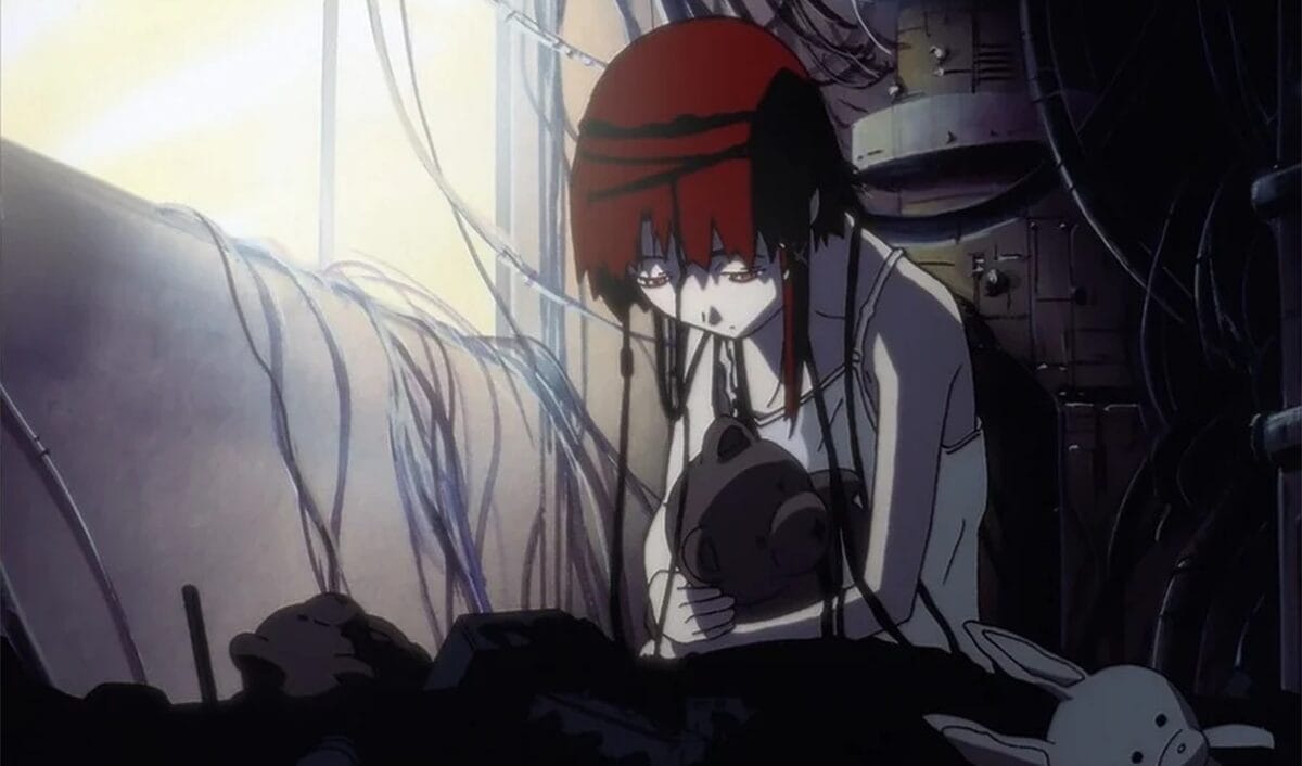Screenshot from Serial Experiments Lain that depicts Lain Iwakura in a white top, ensnared in computer wires. She sullenly holds onto a teddy bear.