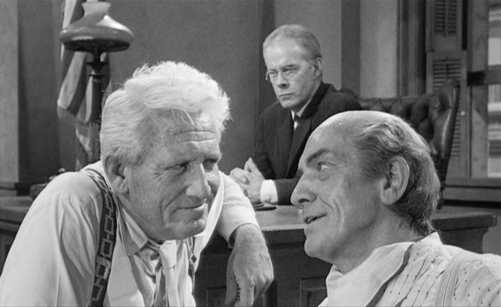 Still from Inherit the Wind, which depicts Spencer Tracy talking to a witness in court