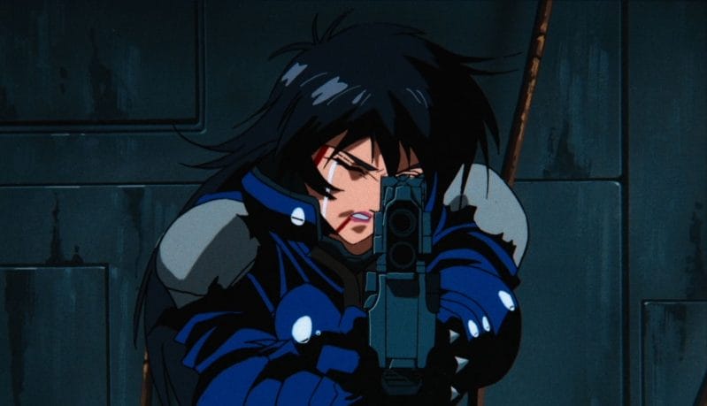 Screenshot from Angel Cop that depicts the titular Angel aiming a pistol at the camera. Tears can be seen streaming down her face, as she's bleeding from her right eye and mouth.