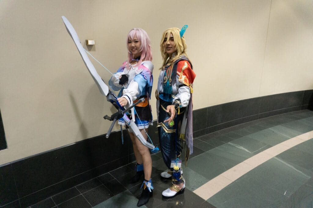Photograph of cosplayers dressed as March 7th and Luchoa from Honkai Star Rail