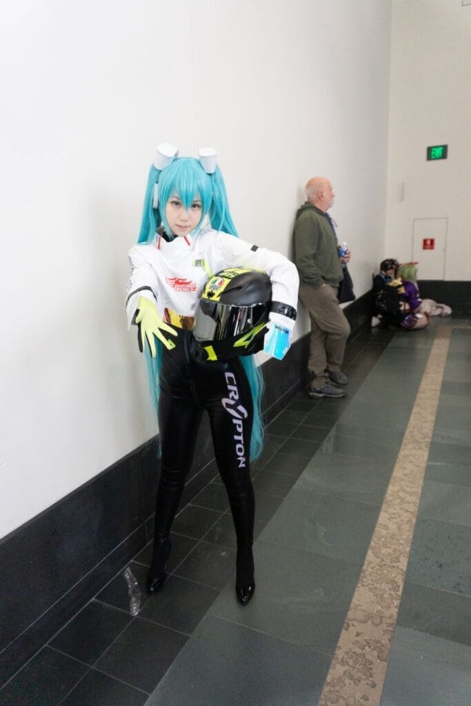Photograph of a cosplayer dressed as Hatsune Miku in her Racing Miku outfit