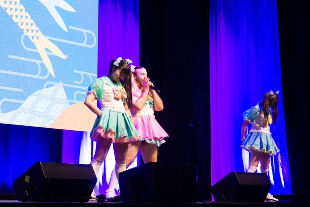 Babybeard - an idol group consisting of Ladybeard, Mahri, and Suzu, performing at Anime Boston 2024's Opening Ceremonies