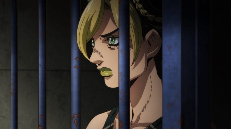 Screenshot from Jojo's Bizarre Adventure: Stone Ocean, which depicts Jolyne Kujoh behind bars, staring angrily off-camera.