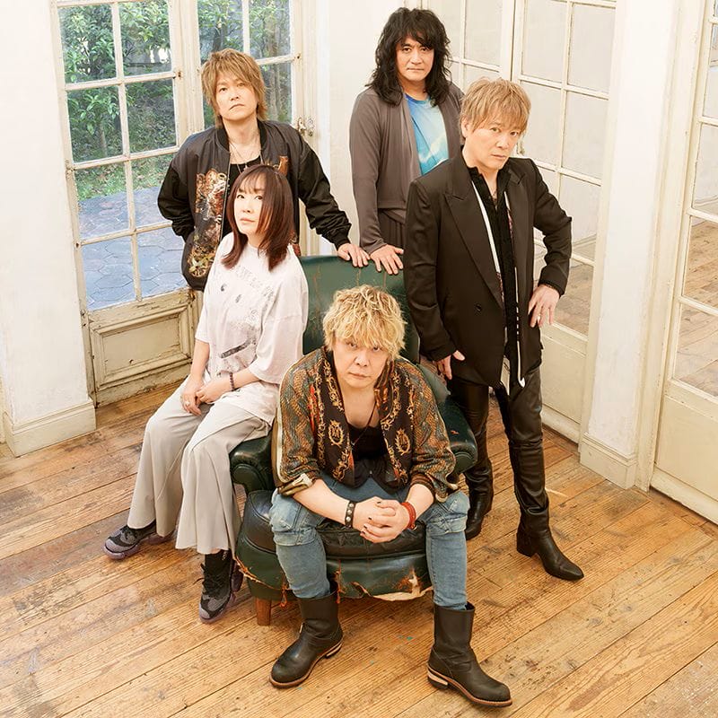 Promotional photo for JAM Project that depicts the group posing in a weathered, empty house